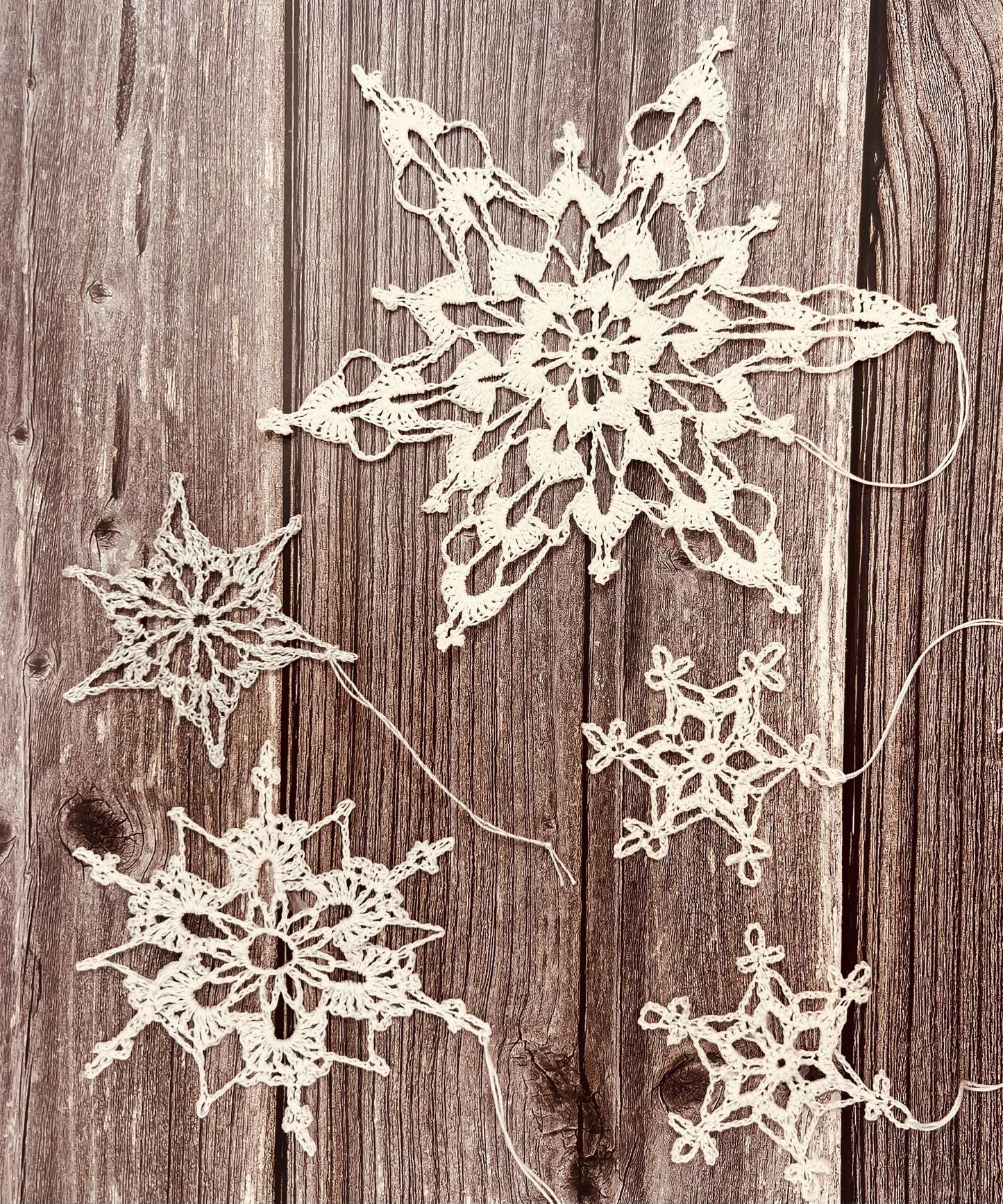 grouping of white lace crocheted ornaments. 100% cotton